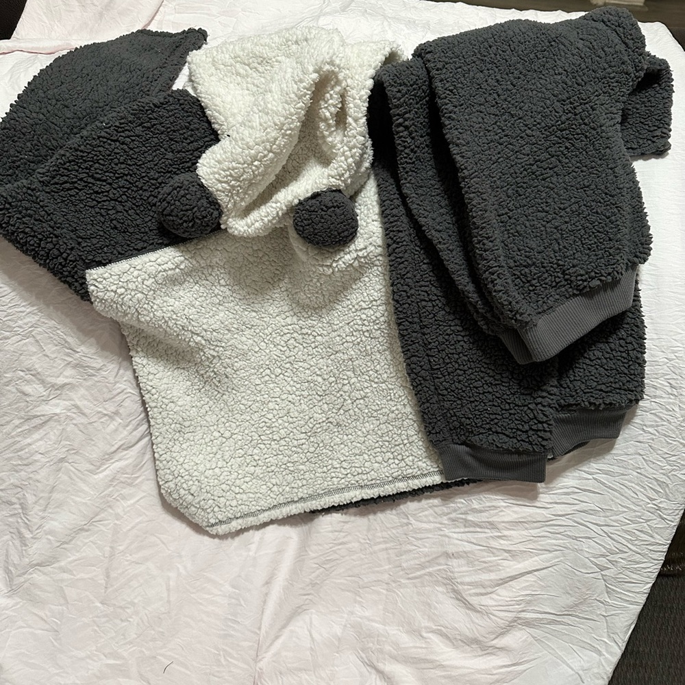 A panda hoodie and pants pajama set. It’s dark grey and white and has panda ears